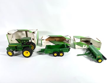 Lot of three John Deere tractor and accessories by Ertl with boxes