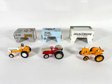 Lot of three International, Ford and John Deere tractors by Ertl with boxes