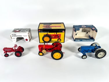 Lot of three International, Massey-Harris and Fordson tractors by Ertl with boxes