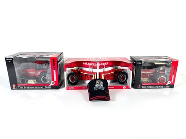 Lot of five International, McCormick Farmall tractors by Ertl in boxes with Collectors Cap