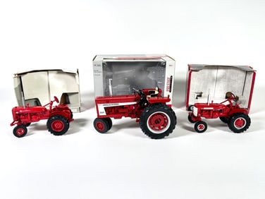 Lot of three McCormick Farmall tractors by Ertl