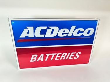NOS AC Delco Batteries single-sided embossed tin garage sign.