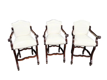 Louis XIV or XIII style carved fruit wood bar stool with faux leather upholstery and nail head trim.