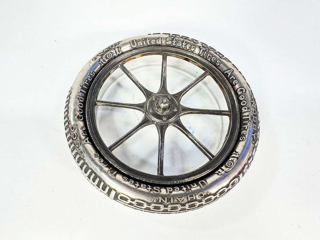 1920s United States Tires metal with glass tire-shaped dealership ashtray.: 1920s United States Tires metal with glass tire-shaped dealership ashtray. Condition 8.0 - 8.5. Size: 6"x6"x1".