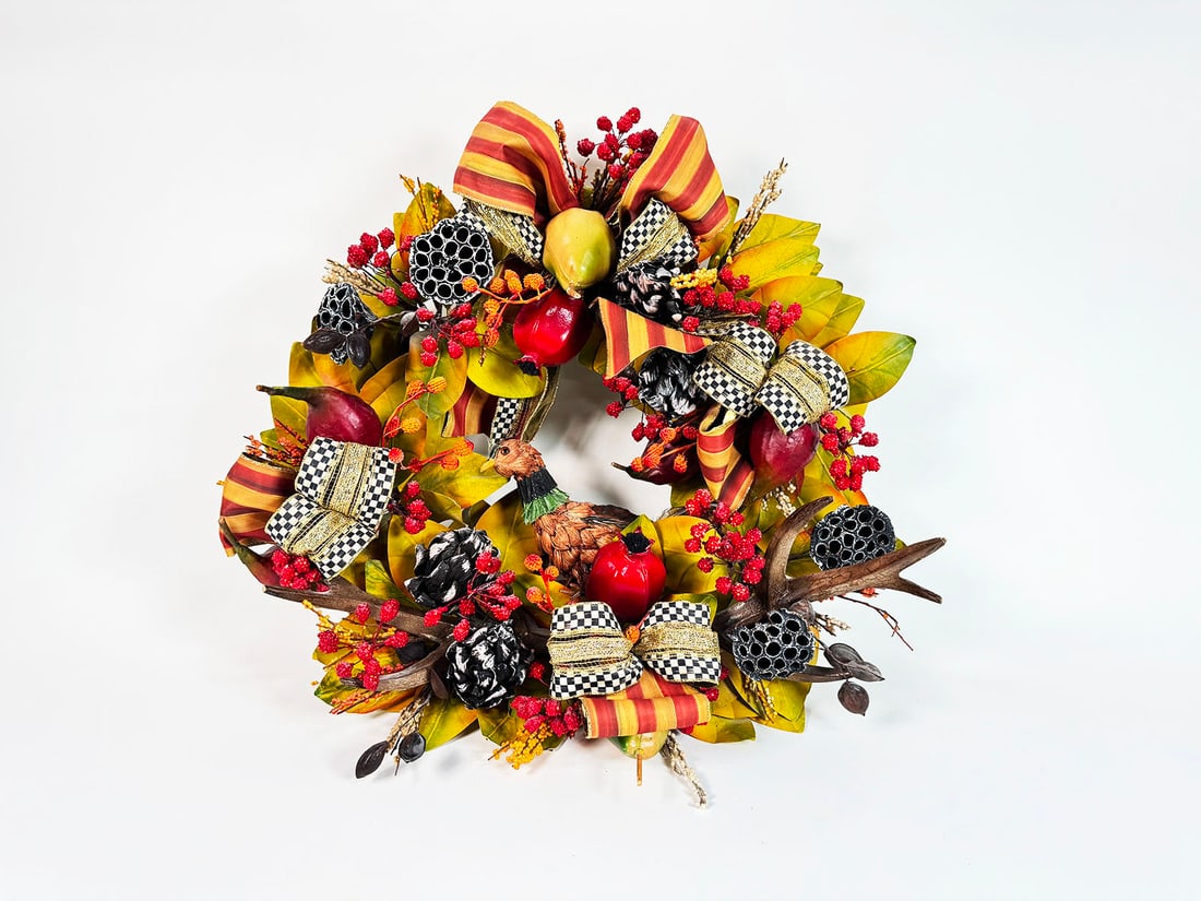 MacKenzie-Childs Autumn Themed Wreath featuring a pheasant, stag horns, fruit and MC Heritage: MacKenzie-Childs Autumn Themed Wreath featuring a pheasant, stag horns, fruit and MC Heritage Striped Ribbon. Condition: Excellent+ - Excellent++. Size: 26"x11"x26".