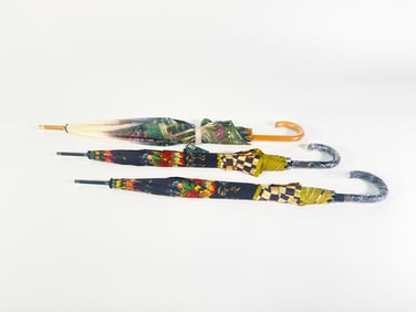 Lot of two MacKenzie-Childs wood handle Umbrellas and a Thomas Kincade umbrella.