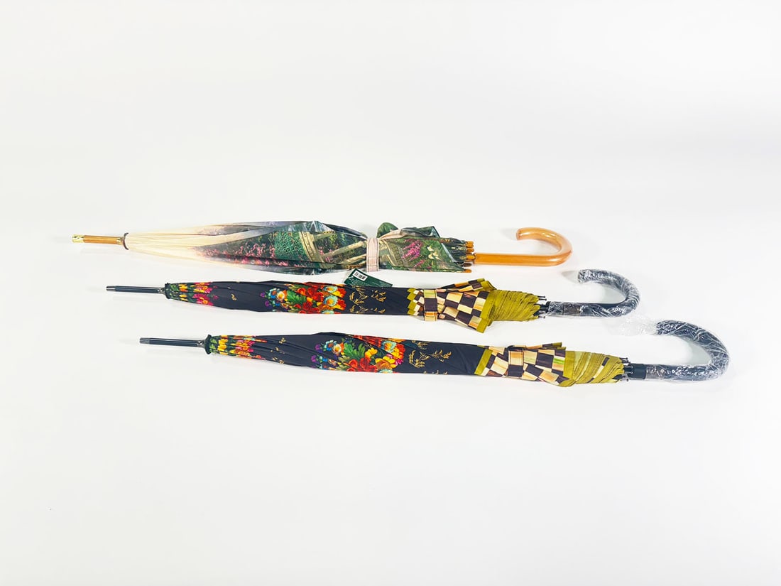 Lot of two MacKenzie-Childs wood handle Umbrellas and a Thomas Kincade umbrella. (1 of 2)