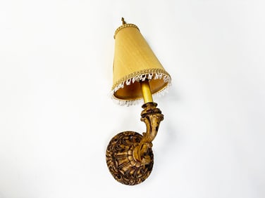 Ornate vintage style wooden wall sconce with a fabric shade and crystal bead trim.