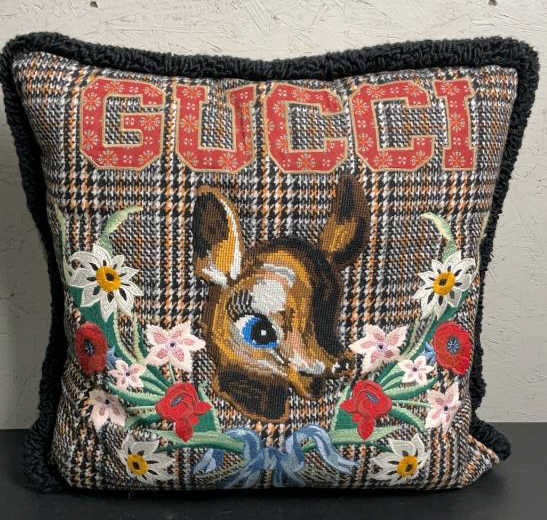 Gucci Embroidered Fawn Cushion: Buyer Premium 10% BP MFG Gucci Embroidered Fawn Cushion Located in: Chattanooga, TN A Gucci fawn cushion with checkered brown, red and multicolor wool blend, needlepoint. Fawn and needlework floral mo