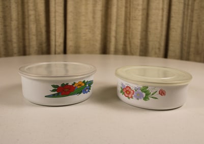 Set of 2 vintage enamel storage containers with plastic lids and floral motifs, in good used