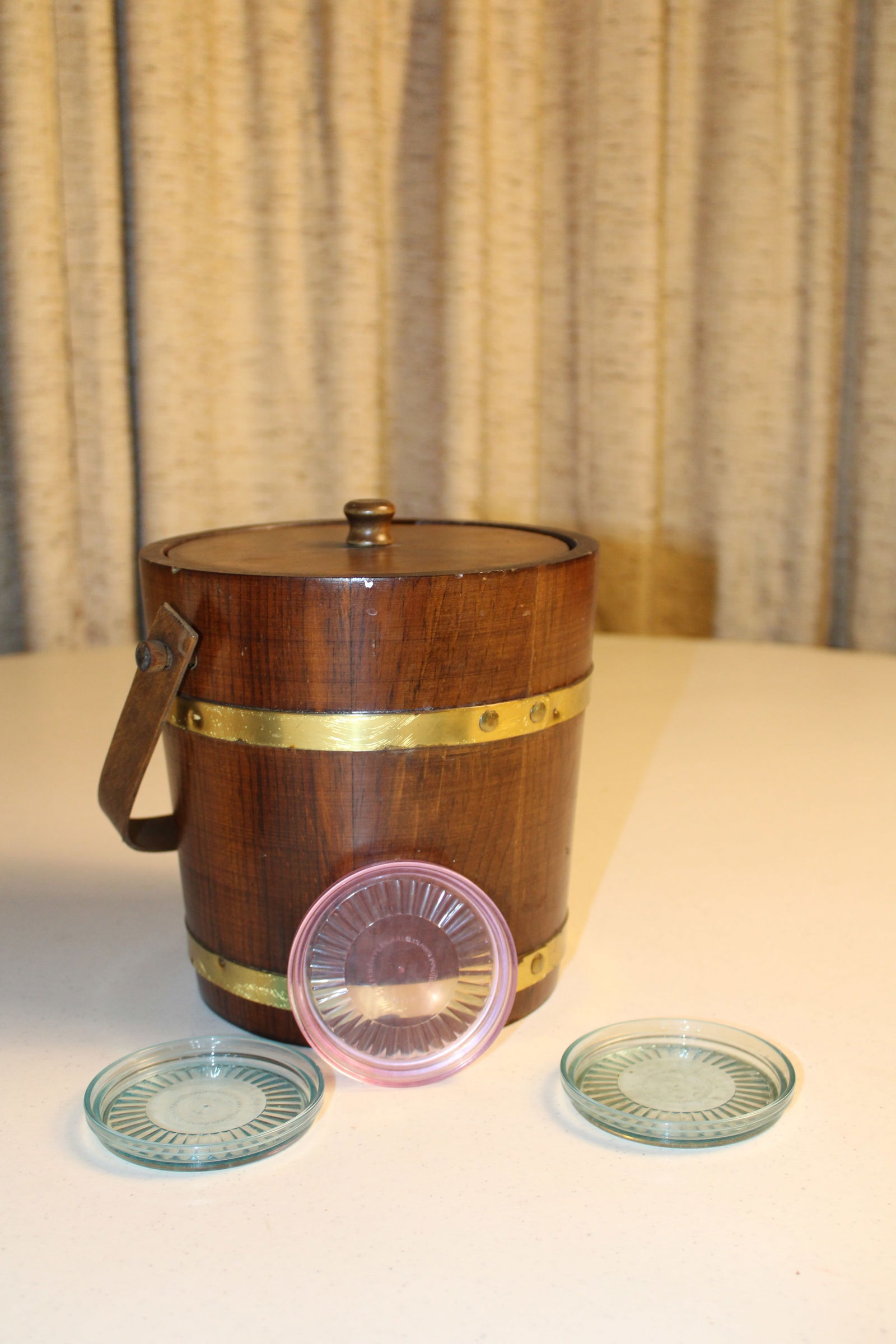Vintage Brass Barrell Ice Bucket: Vintage Wood and Brass Barrell Ice Bucket with 3 Vintage Tupperware clear color coasters. Wood ice bucket with brass details, includes lid, liner, and handle. Ready to entertain on the patio with a vi