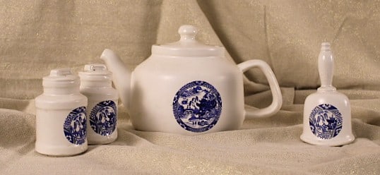 McCoy Tea Pot Bell and S&P: McCoy ceramics or pottery tea pot with lid bell and sat and peper shakers printed with blue willow reminiscent motif. Bell ringer needs repaired but is present, tea pot marked with number possibly 763