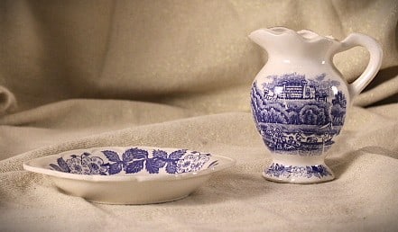 Blue Willow Inspired Miniatures: Blue willow reminiscent miniature pitcher and saucer, no makers mark in good used condition strawberry looking leaves with flowers on saucer