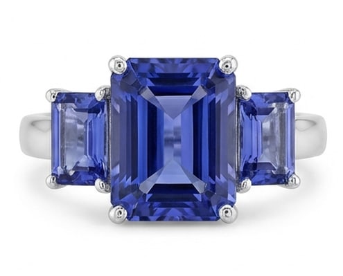 Certified 3.0 Ct Emerald Natural Tanzanite 14K White Gold Three-Stone (Tanzanite Sides) Ring: This certified fine jewelry piece features a 3.0 carat natural Tanzanite in a Emerald cut, crafted in 14K White Gold. The Three-Stone (Tanzanite Sides) design highlights the beauty of the natural cent