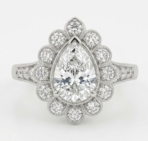 Exquisite 5.00 CT Pear Cut Lab Grown Diamond Scalloped Halo Ring in 14K White Gold: Description This feminine design features a 5.00 Carat Pear Cut Lab Grown Diamond encased in a unique scalloped floral halo The petal inspired setting is adorned with shimmering accent diamonds that c