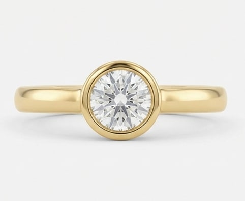Modern 2.00 CT Round Brilliant Cut Lab Grown Diamond Bezel Ring in 14K Yellow Gold: Description This sleek and contemporary ring features a 2.00 Carat Round Brilliant Cut Lab Grown Diamond in a secure high-polish bezel setting. The minimalist 14K Yellow Gold band ensures a comfortabl