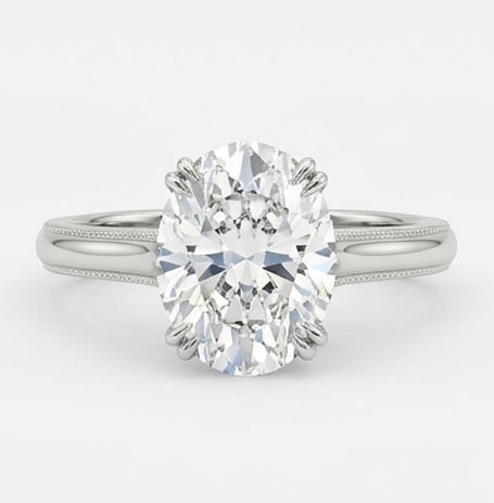 Stunning 8.00 CT Oval Cut Lab Grown Diamond Milgrain Solitaire Ring in 14K White Gold: Description An elegant 8.00 Carat Oval Cut Lab Grown Diamond takes center stage in this refined solitaire setting. The 14K White Gold band is adorned with a delicate milgrain border providing a sophis