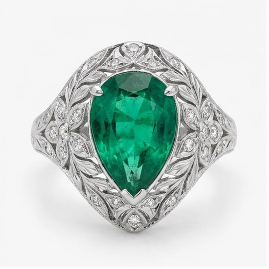 5.00 CT Emerald Lab-Grown Ring in White Gold: An exceptional 5.00 carat lab-grown emerald ring, expertly crafted in luxurious White Gold. The pear cut green emerald in a vintage leaf/floral setting with pave details design highlights the