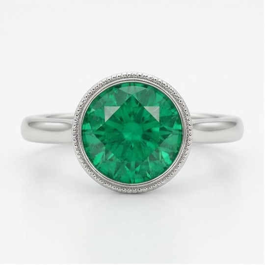 5.00 CT Emerald Lab-Grown Ring in White Gold: An exceptional 5.00 carat lab-grown emerald ring, expertly crafted in luxurious White Gold. The round cut green emerald in a milgrain bezel setting with a plain band design highlights the brilliance