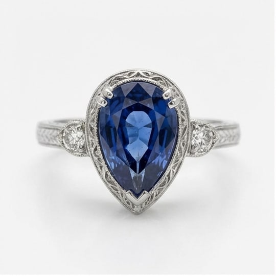 5.00 CT Sapphire Lab-Grown Ring in White Gold: An exceptional 5.00 carat lab-grown sapphire ring, expertly crafted in luxurious White Gold. The pear shape with vintage milgrain bezel and shoulder accents design highlights the brilliance of the lab