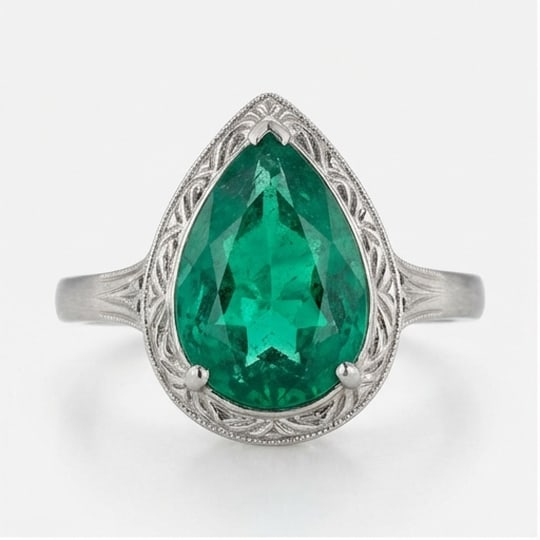 10.00 CT Emerald Lab-Grown Ring in White Gold: An exceptional 10.00 carat lab-grown emerald ring, expertly crafted in luxurious White Gold. The pear shape with vintage bezel and engraved shoulders design highlights the brilliance of the lab-grown