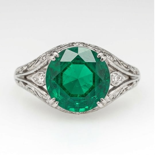 10.00 CT Emerald Lab-Grown Ring in White Gold: An exceptional 10.00 carat lab-grown emerald ring, expertly crafted in luxurious White Gold. The round cut with vintage filigree split shank design highlights the brilliance of the lab-grown center