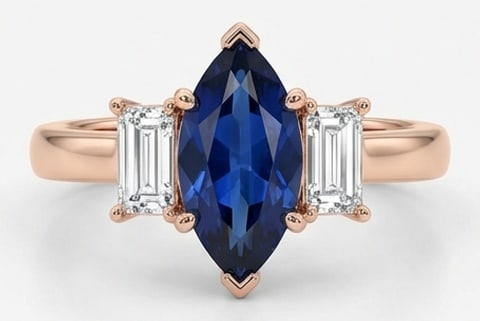 5.00 CT Sapphire Lab-Grown Ring in Rose Gold: An exceptional 5.00 carat lab-grown sapphire ring, expertly crafted in luxurious Rose Gold. The marquise cut with emerald cut side stones (three-stone) design highlights the brilliance of the lab-grow