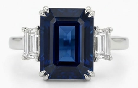 10.00 CT Sapphire Lab-Grown Ring in White Gold: An exceptional 10.00 carat lab-grown sapphire ring, expertly crafted in luxurious White Gold. The emerald cut blue sapphire with trapezoid/baguette side stones design highlights the brilliance of the
