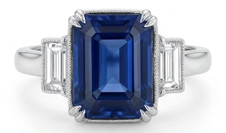 10.00 CT Sapphire Lab-Grown Ring in White Gold: An exceptional 10.00 carat lab-grown sapphire ring, expertly crafted in luxurious White Gold. The emerald cut sapphire three-stone with trapezoid/baguette sides design highlights the brilliance of the