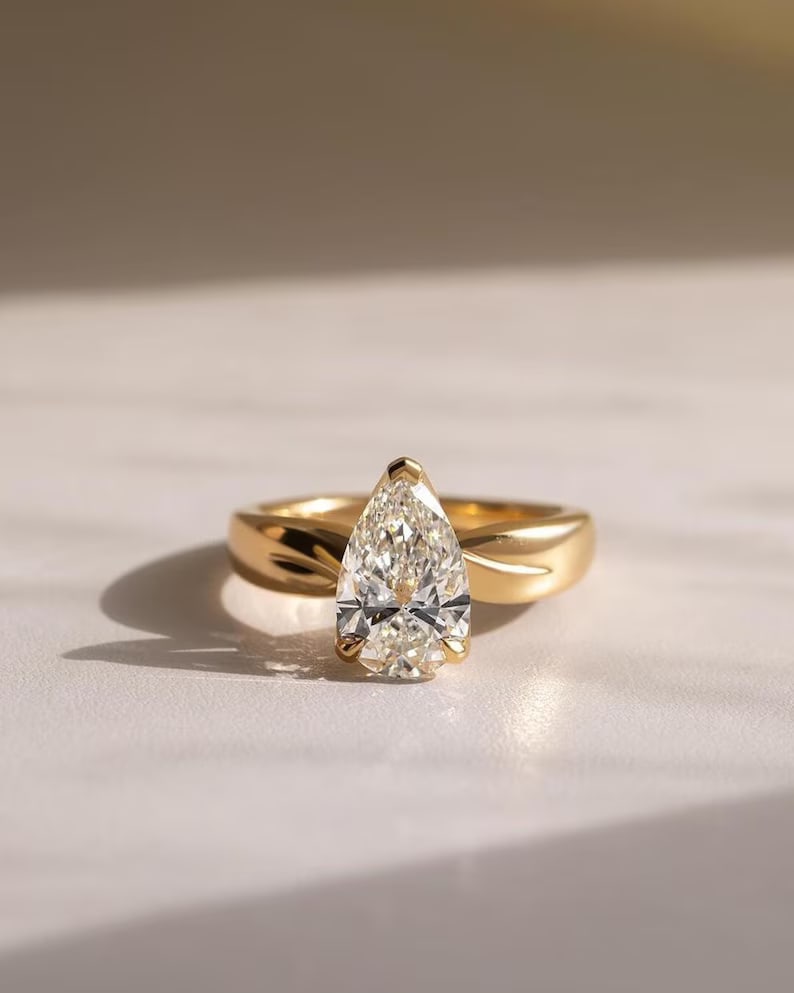 Luxury GIA Certified 1.50 Ct Pear Cut Natural Diamond Ring in 14K Yellow Gold: Elegant and luxurious engagement ring featuring an approximately 1.50 carat natural diamond in a refined pear cut. Beautifully crafted in premium 14K Yellow Gold, this sophisticated ring showcases a s