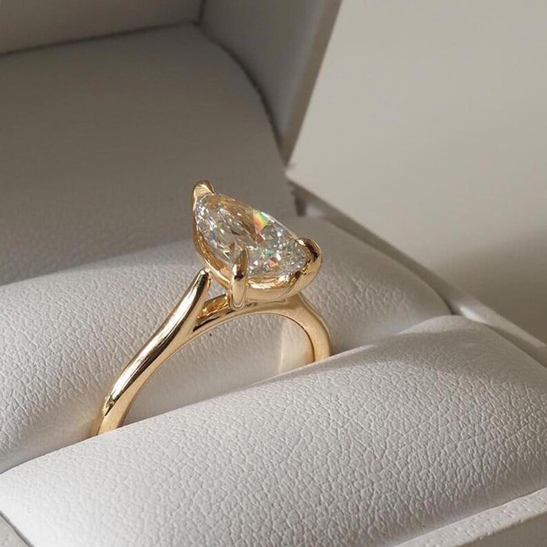 Luxury GIA Certified 1.70 Ct Pear Cut Natural Diamond Ring in 14K Yellow Gold: Exquisite luxury engagement ring showcasing an approximately 1.70 carat natural diamond in a refined pear cut. Beautifully crafted in premium 14K Yellow Gold, this elegant ring features a classic high