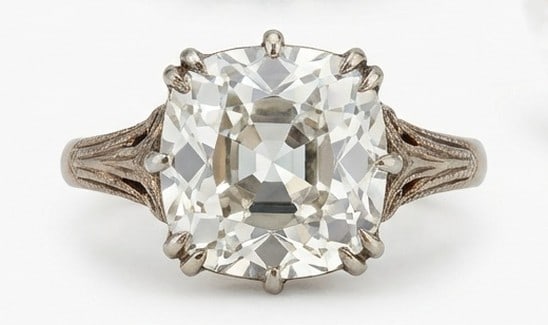 IGI Lab Grown 4.00 Ct Cushion Old Mine Look Diamond Ring – Antique Solitaire with Filigree: IGI Certified Lab Grown Diamond Center Stone Color E-F Clarity VVS1-VS1Designed to stand out, this ring presents a 4.00 carat lab grown Cushion (Old Mine Look) center diamond. Set in White Gold , the