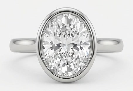 IGI Lab Grown 4.00 Ct Oval Diamond Ring – Modern Sleek Bezel Set Solitaire – / in 14K White Gold: IGI Certified Lab Grown Diamond Center Stone Color E-F Clarity VVS1-VS1 Distinctive in silhouette, this ring centers on a 4.00 carat lab grown Oval center diamond. Featuring the Modern Sleek Bezel Set