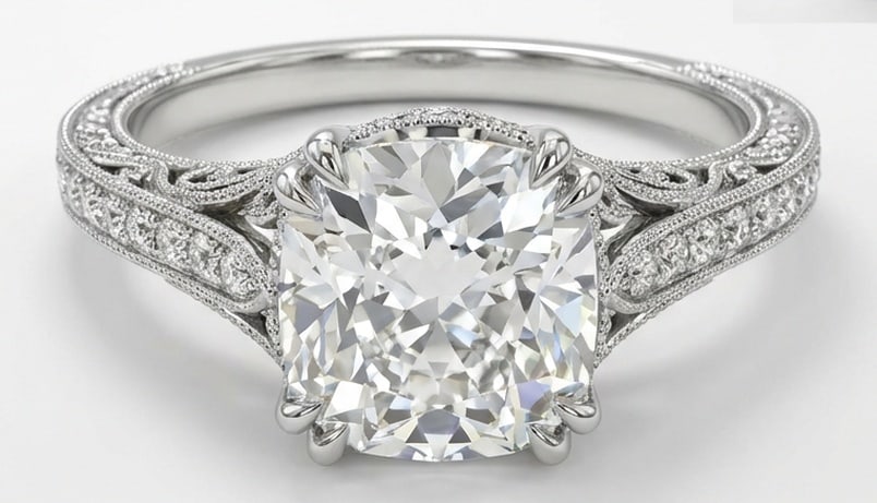 IGI Lab Grown 6.00 Ct Cushion (Modified Brilliant) Diamond Ring – Vintage Cushion Halo with Scroll: IGI Certified Lab Grown Diamond Center Stone Color E-F Clarity VVS1-VS1 Side Stone Lab Grown Diamond Striking and elegant, this ring features a 6.00 carat lab grown Cushion (Modified Brilliant) center