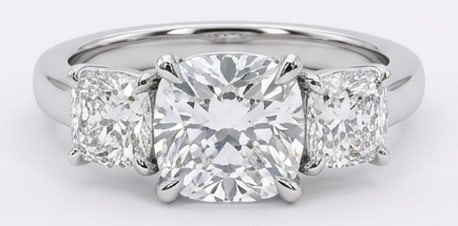 IGI Lab Grown 4.00 Ct Cushion Diamond Ring – Classic three-stone prong setting with polished band: IGI Certified Lab Grown Diamond Center Stone Color E-F Clarity VVS1-VS1 Side Stone Lab Grown Diamond Distinctive in silhouette, this ring centers on a 4.00 carat lab grown Cushion center diamond. Feat