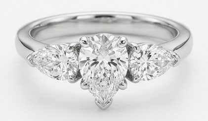 IGI Lab Grown 4.00 Ct Pear Diamond Ring – Simple three-stone setting with pear side stones and: IGI Certified Lab Grown Diamond Center Stone Color E-F Clarity VVS1-VS1 Side Stone Lab Grown Diamond Beautifully styled, this ring is anchored by a 4.00 carat lab grown Pear center diamond as the foca