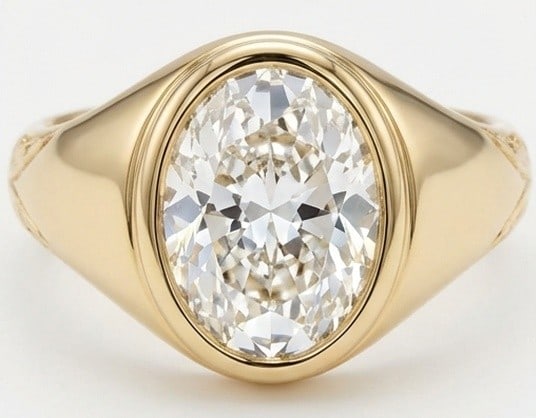 IGI Lab Grown 5.00 Ct Oval Diamond Ring – Heavy signet-style bezel setting with engraved details: IGI Certified Lab Grown Diamond Center Stone Color E-F Clarity VVS1-VS1 Bold yet refined, this design showcases a 5.00 carat lab grown Oval center diamond. Yellow Gold gives the piece a refined, neutr