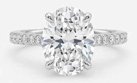 IGI Lab Grown 6.00 Ct Oval Diamond Ring – Oval solitaire with pave-set diamond band – in 14K: IGI Certified Lab Grown Diamond Center Stone Color E-F Clarity VVS1-VS1 Side Stone Lab Grown Diamond Graceful and eye-catching, this ring is set with a 6.00 carat lab grown Oval center diamond. White