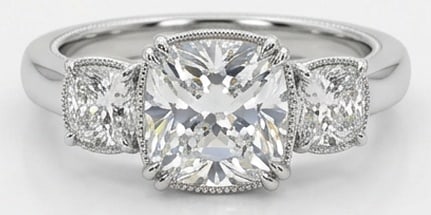 Lab Grown 5.00 Ct Cushion (Modified Brilliant) Diamond Ring – Classic Three-Stone Cushion with: Sophisticated and modern, this ring is defined by a 5.00 carat lab grown Cushion (Modified Brilliant) center diamond. Featuring the Classic Three-Stone Cushion with Milgrain Edges theme, offering a di