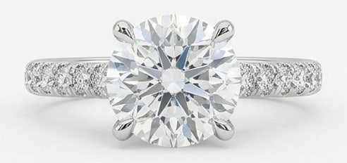 Lab Grown 8.00 Ct Round Diamond Ring – Solitaire setting with braided/chevron pave diamond band: Designed to stand out, this ring presents a 8.00 carat lab grown Round center diamond. White Gold gives the piece a refined, neutral foundation for daily wear or events. The overall style follows a so