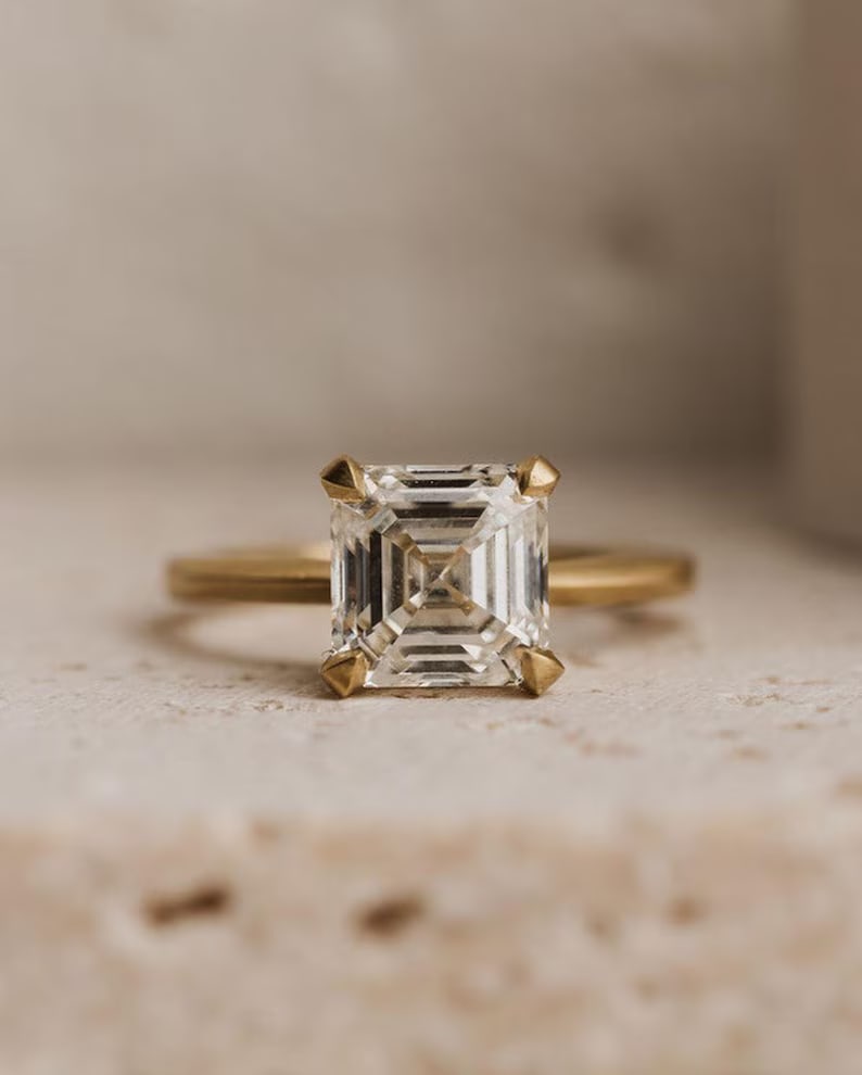 Luxury IGI Certified 2.50 Ct Asscher Cut Lab Grown Diamond Ring in 14K Yellow Gold: An elegant and luxurious engagement ring featuring an approximately 2.50 carat lab grown diamond in a refined asscher cut cut. Beautifully crafted in premium 14K Yellow Gold, this ring showcases a cla