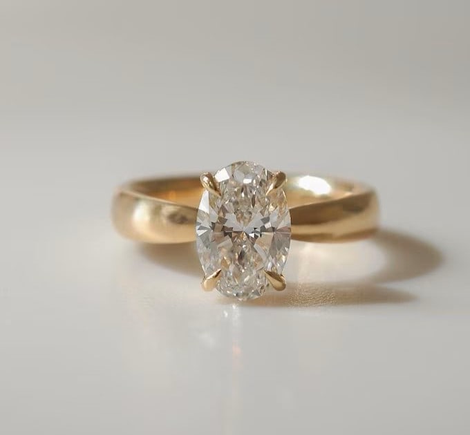 Luxury IGI Certified 1.90 Ct Oval Cut Lab Grown Diamond Ring in 14K Yellow Gold: An elegant and luxurious engagement ring featuring an approximately 1.90 carat lab grown diamond in a refined oval cut cut. Beautifully crafted in premium 14K Yellow Gold, this ring showcases a wide b