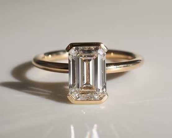 Luxury GIA Certified 1.70 Ct Emerald Cut Lab Grown Diamond Ring in 14K Yellow Gold: An elegant and luxurious engagement ring featuring an approximately 1.70 carat lab grown diamond in a refined emerald cut cut. Beautifully crafted in premium 14K Yellow Gold, this ring showcases a bez