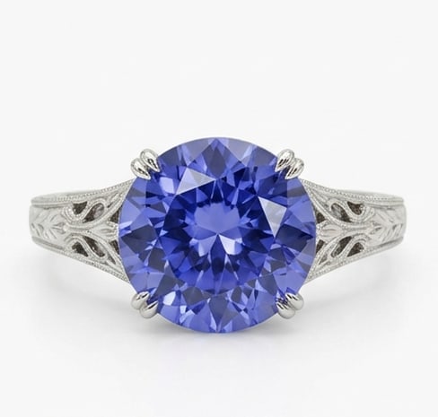 3.0 Ct Oval Natural Tanzanite 14K White Gold Vintage Scroll/Filigree Solitaire Ring Certified: This certified fine jewelry piece features a 3.0 carat natural Tanzanite in a Oval cut, crafted in 14K White Gold. The Vintage Scroll/Filigree Solitaire design highlights the beauty of the natural cen