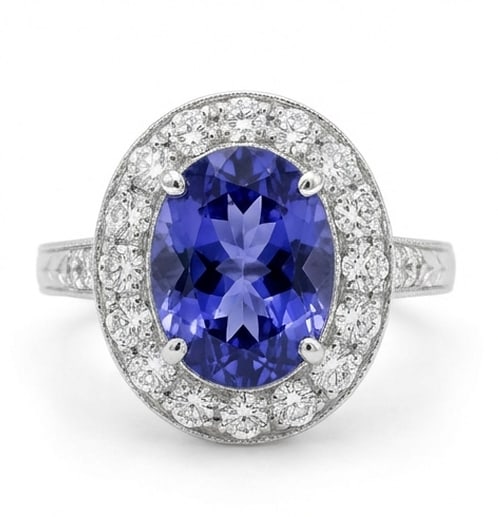 2.5 Ct Oval Natural Tanzanite 14K White Gold Vintage Halo with Engraved Shank Ring Certified: This certified fine jewelry piece features a 2.5 carat natural Tanzanite in a Oval cut, crafted in 14K White Gold. The Vintage Halo with Engraved Shank design highlights the beauty of the natural cent