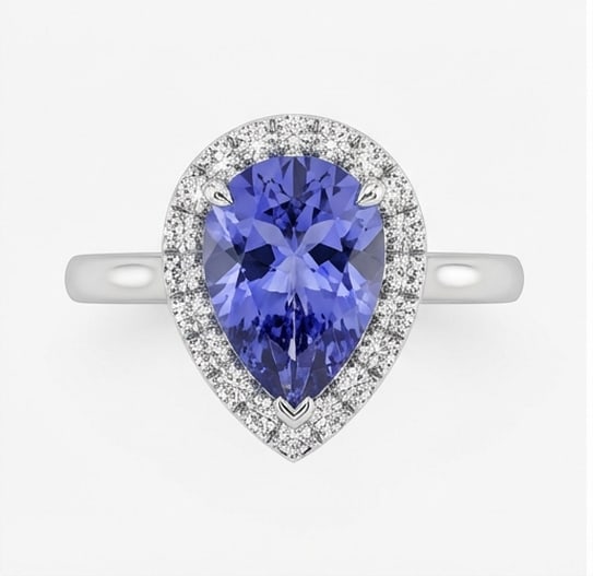 2.0 Ct Pear Natural Tanzanite 14K White Gold Halo Setting with Pave Shank Ring Certified: This certified fine jewelry piece features a 2.0 carat natural Tanzanite in a Pear cut, crafted in 14K White Gold. The Halo Setting with Pave Shank design highlights the beauty of the natural center s