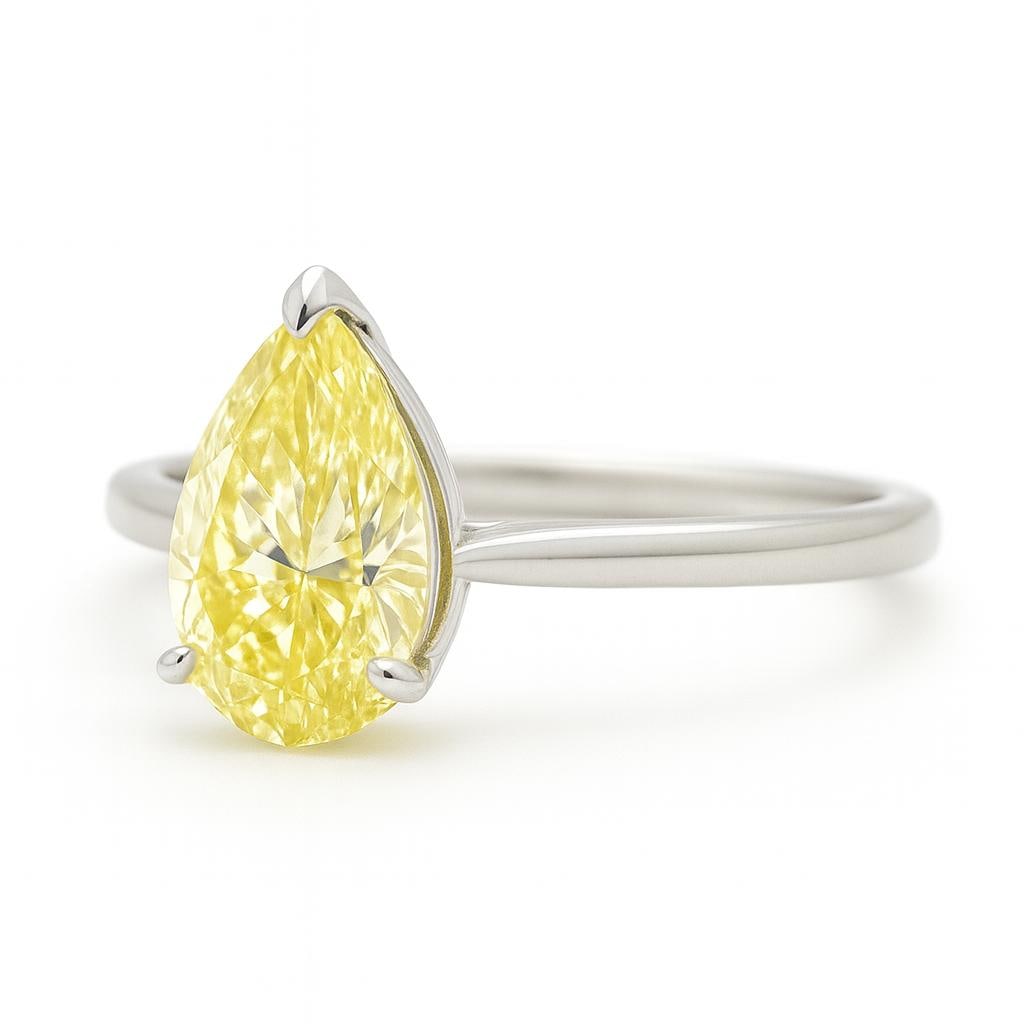 3 Ct Pear Shape Fancy Yellow Certified Lab Grown Diamond Solitaire Ring in 14K White Gold: A captivating 3 carat fancy yellow certified lab grown diamond ring featuring an elegant pear shaped center stone in a timeless solitaire design. Crafted in polished 14K white gold, this refined ring 