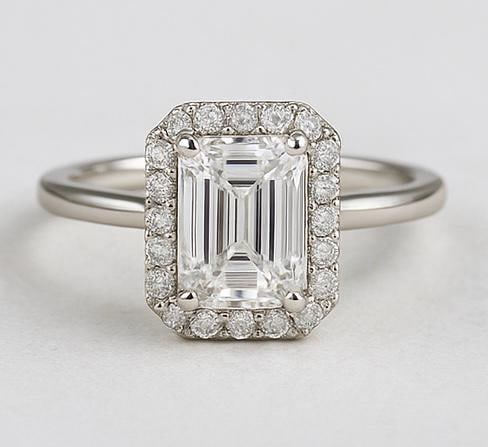 4.50 CT Lab Grown Emerald Cut Diamond Halo Ring in 14K White Gold: Elegant 4.50 carat lab grown emerald cut diamond centerpiece, surrounded by a halo of lab grown round diamonds. Crafted in 14K white gold with a sleek high-polish band, creating a refined and timeless
