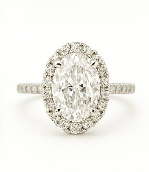 5 CT Lab Grown Oval Cut Diamond Halo Ring with Pavé Band in 14K White Gold: Elegant 5 carat lab grown oval cut diamond centerpiece, encircled by a halo of sparkling lab grown round diamonds. The pavé-set band adds extra brilliance, crafted in 14K white gold with a refined hi