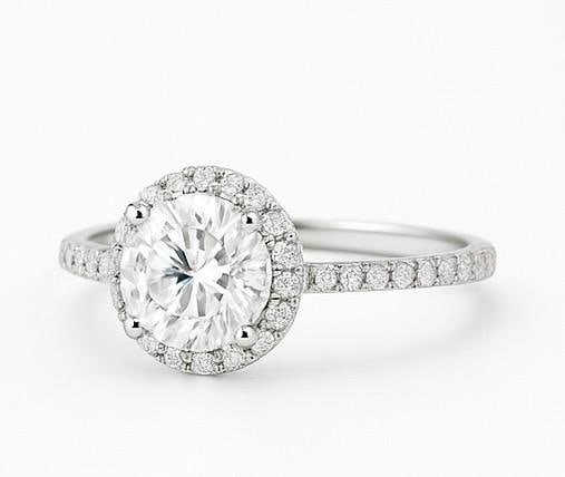 3 CT Lab Grown Round Brilliant Cut Diamond Halo Ring with Pavé Band in 14K White Gold: Dazzling 3 carat lab grown round brilliant cut diamond centerpiece, encircled by a halo of lab grown round diamonds. The pavé-set band enhances brilliance, crafted in 14K white gold with a polished f